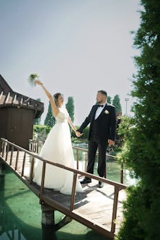 Bride and groom celebrating their wedding on a picturesque wooden bridge.