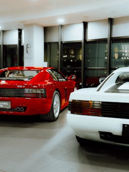 Red and white luxury sports cars displayed indoors, showcasing elegance and classic design.